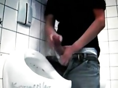 Jerking huge cock at public toilet